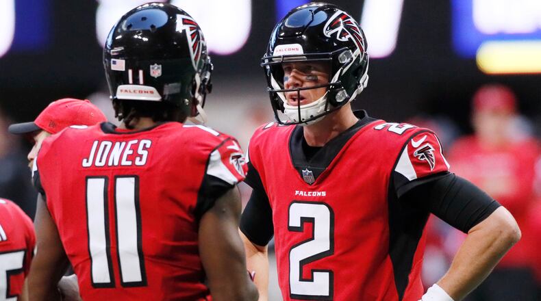 Atlanta Falcons wide receiver Julio Jones (11) and quarterback Matt Ryan (2) confer in the huddle after they failed to connect on a pass attempt against the Baltimore Ravens Sunday, Dec. 2, 2018, at Mercedes-Benz Stadium in Atlanta.