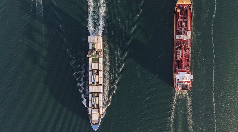 A bulk carrier and a cargo ship transit the Panama Canal in Panama City, Thursday, March 12, 2026. (AP Photo/Matias Delacroix)