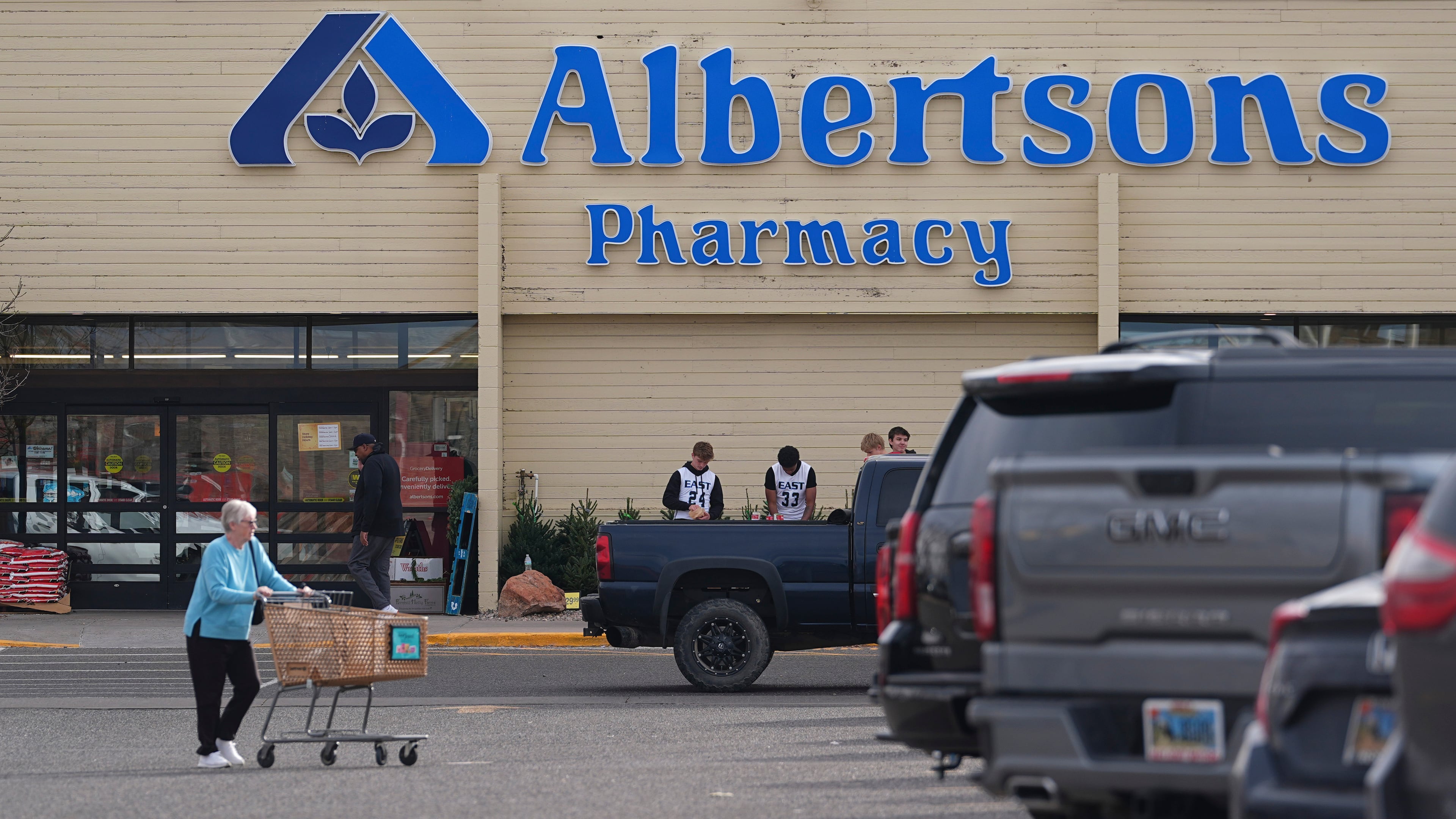 FILE - Shoppers head into an Albertson's grocery store Nov. 23, 2024, in Cheyenne, Wyo. (AP Photo/David Zalubowski, File)