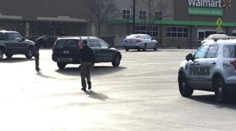 Officers converge on a shopping center in Dunwoody in search of an armed robbery suspect. The man was shot by an officer and later died.