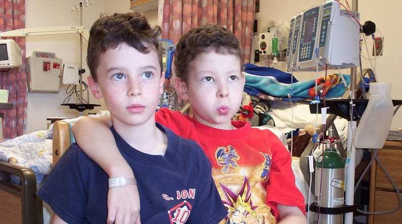 Killian Owen right with his twin brother Garrett playing video games while Killian was being treated with an experimental therapy at the National Institutes of Health in Bethesda, Maryland. The photo was taken in 2003, two months before Killian died. (Photo contributed by Owen family)