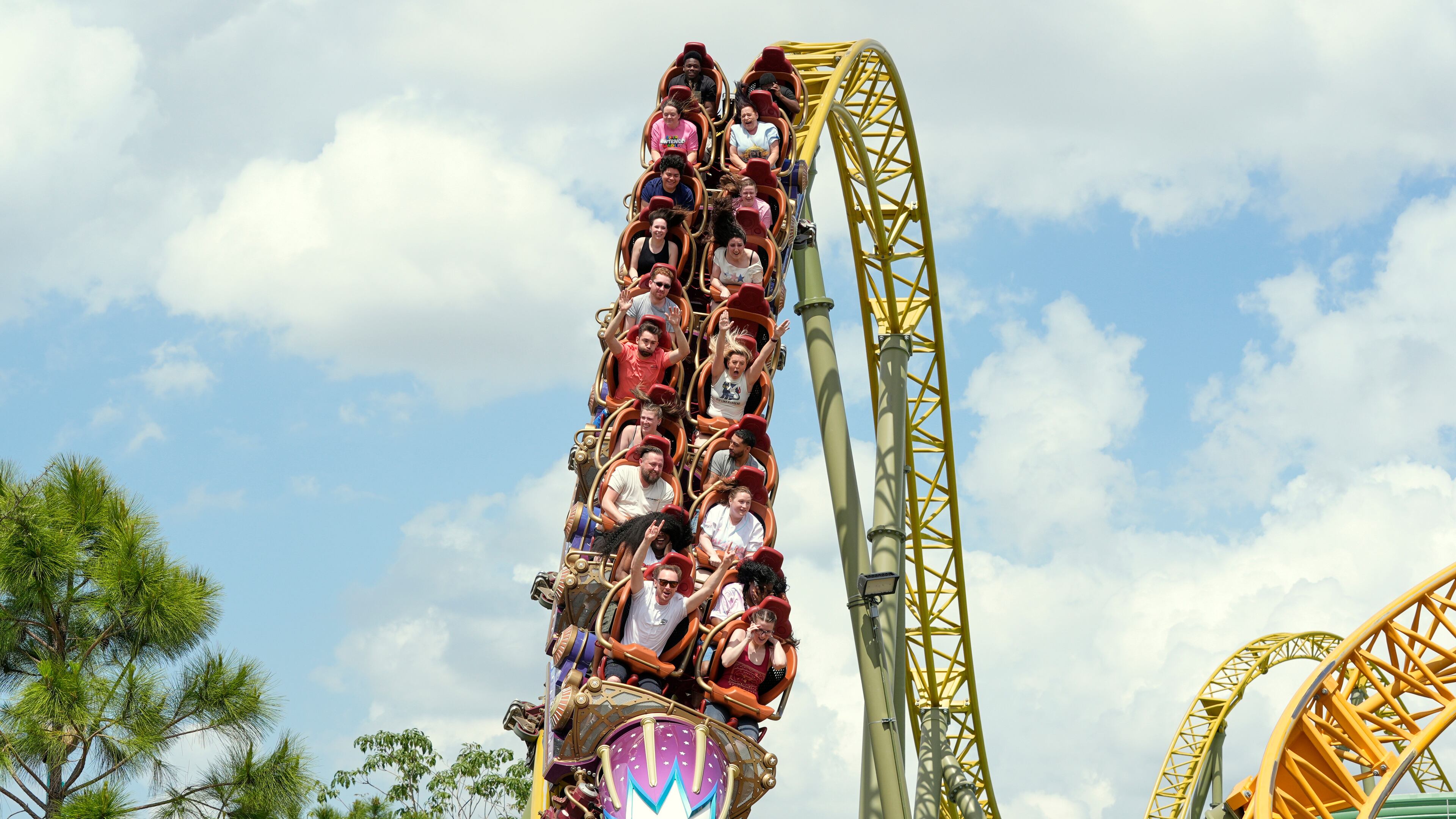 FILE - Guests ride on the Stardust Racers roller coaster at Epic Universe Theme Park at Universal Resort Orlando, April 10, 2025, in Orlando, Fla. (AP Photo/John Raoux, file)