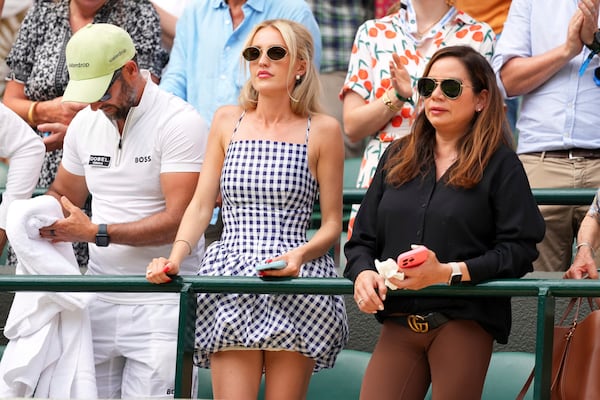 Taylor Fritz's girlfriend, Morgan Riddle, centre, watches Taylor Fritz of the U.S. playing the first round men's singles match against Giovanni Mpetshi Perricard of France at the Wimbledon Tennis Championships in London, Tuesday, July 1, 2025.(AP Photo/Kirsty Wigglesworth)