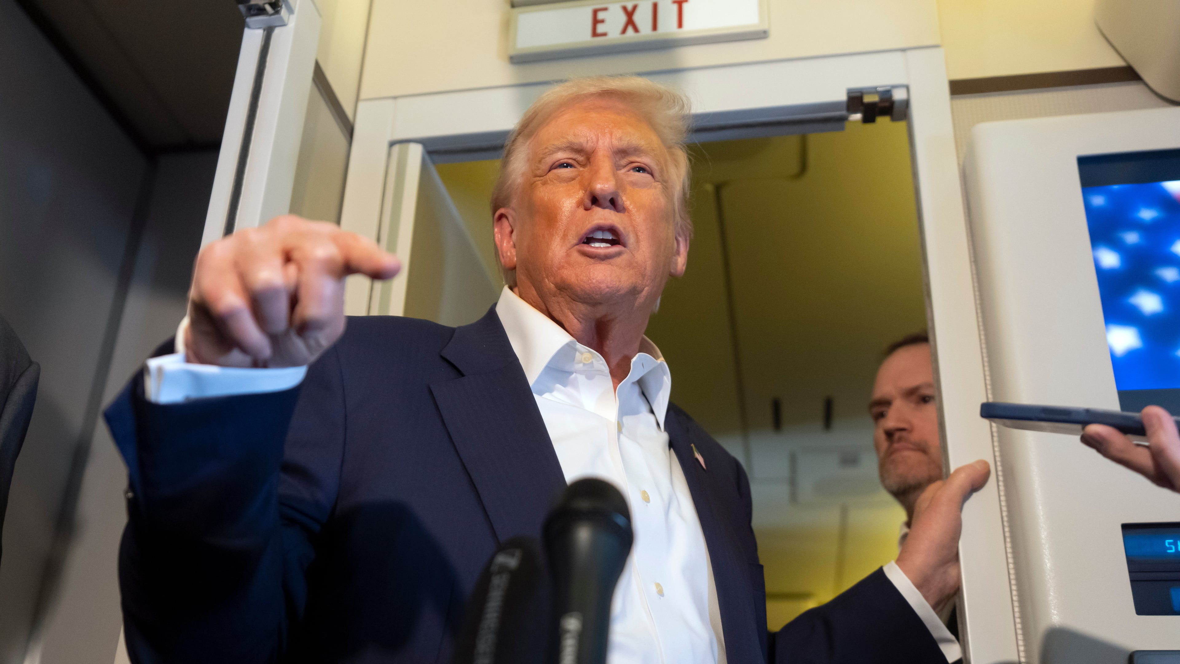 President Donald Trump speaks to reporters aboard Air Force One while traveling from Kuala Lumpur, Malaysia, to Tokyo, Japan, Monday, Oct. 27, 2025. (AP Photo/Mark Schiefelbein)