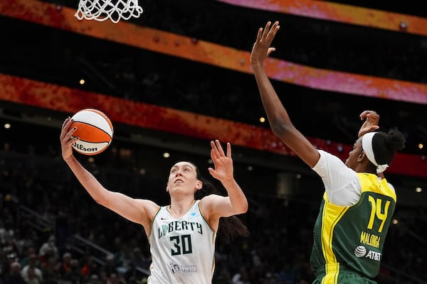 New York Liberty forward Breanna Stewart (30) goes to the basket against Seattle Storm center Dominique Malonga (14) during the first half of a WNBA basketball game Sunday, June 22, 2025, in Seattle. (AP Photo/Lindsey Wasson)