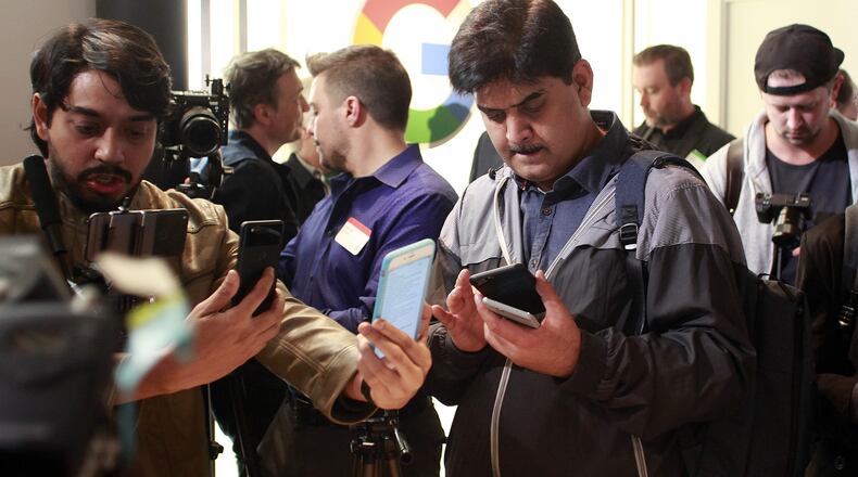 Media analysts take cellphone pictures of Google’s new Pixel 2 cell phones unveiled Wednesday, Oct. 4, 2017, at the SFJazz Center in San Francisco. (Karl Mondon/Bay Area News Group/TNS)