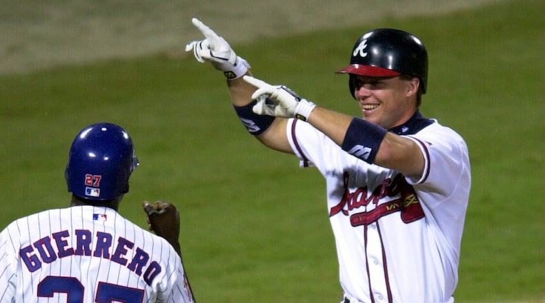 000711 - ATLANTA, GA.: Chipper Jones celebrates his home run with NL teammate Vladimir Guerrero in the third inning Tuesday evening, 7/11/00 at Turner Field in Atlanta in the All-Star Game. (PHOTO BY FRANK NIEMEIR/STAFF)