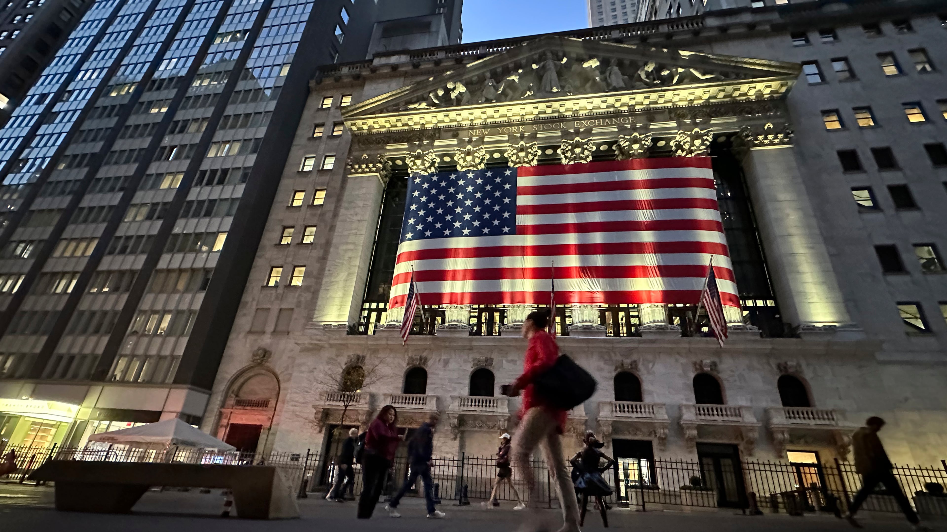 FILE - People pass the New York Stock Exchange on Nov. 5, 2024, in New York. (AP Photo/Peter Morgan, File)