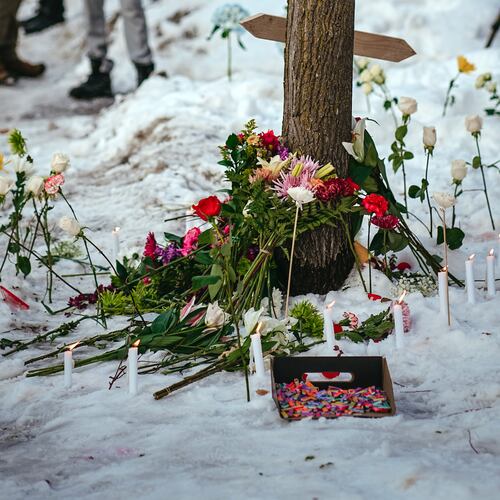 A makeshift memorial has begins near the site where a federal ICE officer is accused of killing a 37-year-old woman Wednesday (Jamie Kelter Davis/The New York Times)