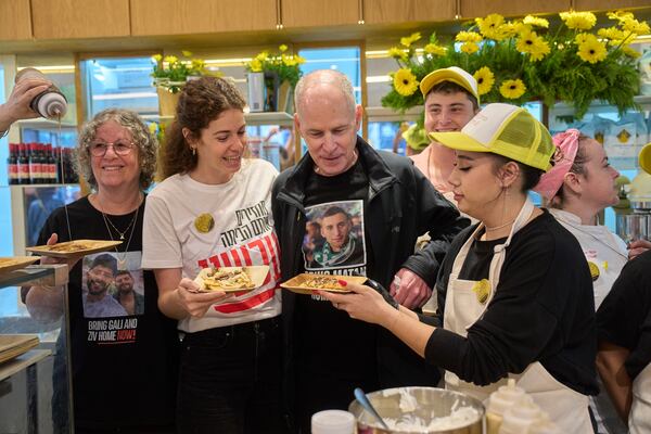 American-Israeli Keith Siegel, who was held hostage by Hamas in Gaza before being freed last month, talks with his family at the opening of the "Keith Siegel Pancake House" in Tel Aviv, Israel, Wednesday, March 26, 2025. (Photo/Ohad Zwigenberg)