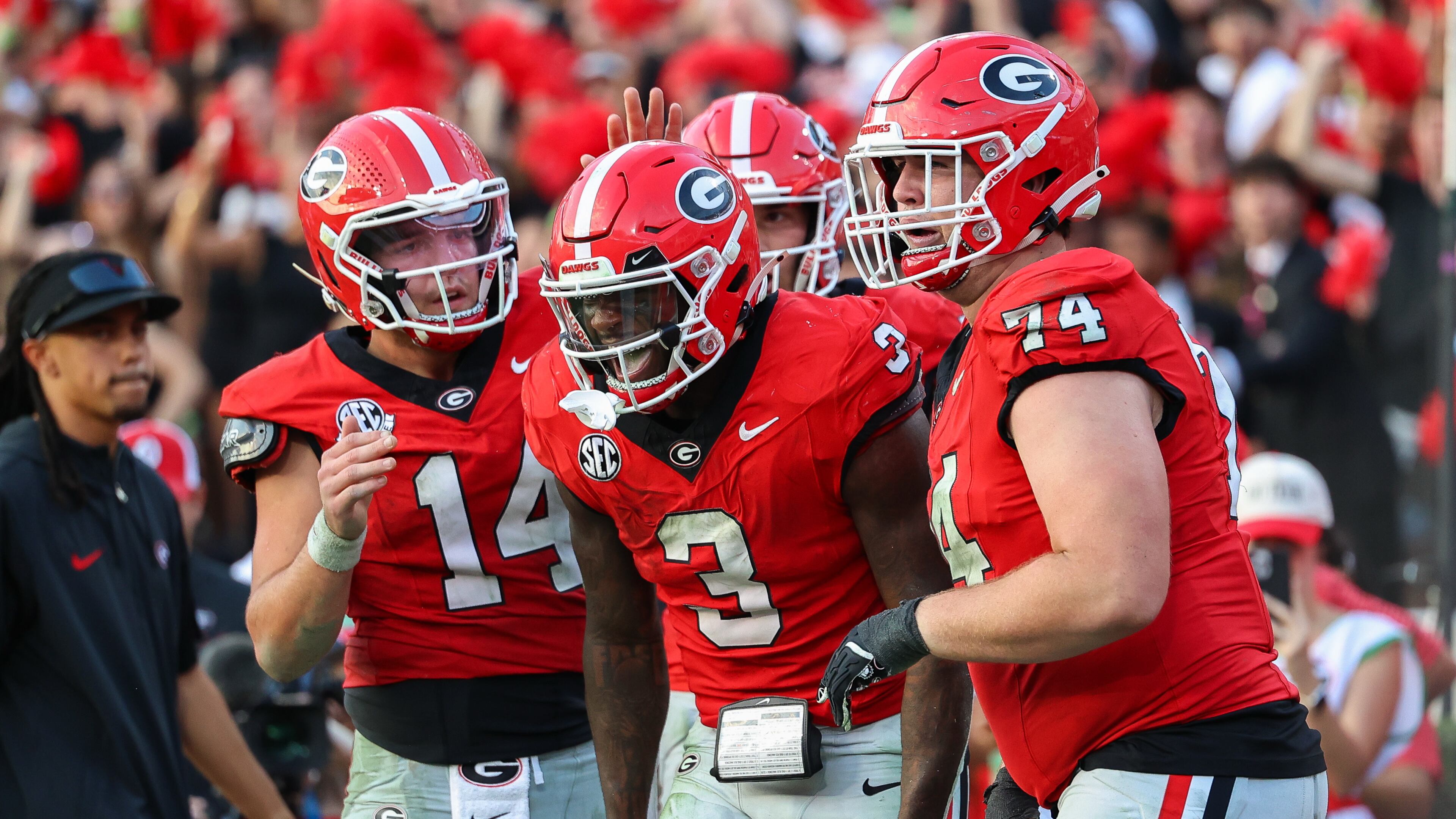 Georgia running back Nate Frazier (3) reacts with quarterback Gunner Stockton (14) and offensive lineman Drew Bobo (74) after scoring a touchdown during the second half of an NCAA college football game against Mississippi, Saturday, Oct. 18, 2025, in Athens, Ga. (AP Photo/Colin Hubbard)
