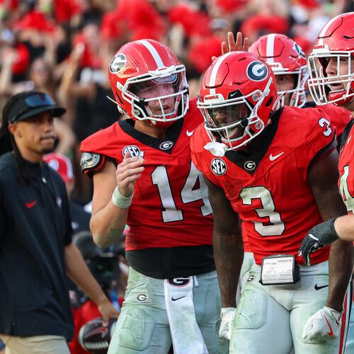 Georgia running back Nate Frazier (3) reacts with quarterback Gunner Stockton (14) and offensive lineman Drew Bobo (74) after scoring a touchdown during the second half of an NCAA college football game against Mississippi, Saturday, Oct. 18, 2025, in Athens, Ga. (AP Photo/Colin Hubbard)