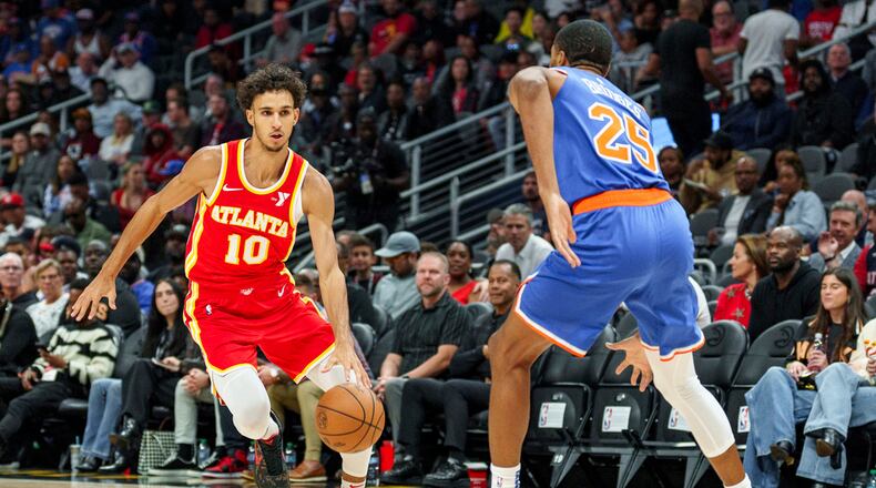 Atlanta Hawks forward Zaccharie Risacher (10) drives the lane while guarded by New York Knicks forward Mikal Bridges (25) during the first half of an NBA basketball game, Wednesday, Nov. 6, 2024, in Atlanta. (AP Photo/Jason Allen)