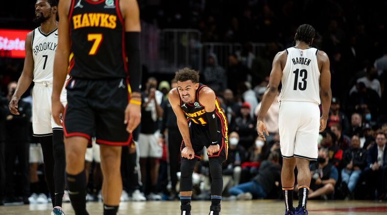 The Hawks' Trae Young (11) grimaces during a game between the Atlanta Hawks and the Brooklyn Nets at State Farm Arena in Atlanta, GA., on Friday, December 10, 2021. The Nets won 113-105. (Photo/ Jenn Finch)