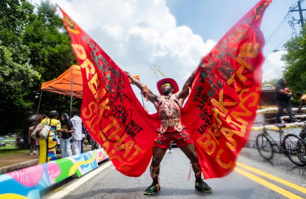 Ajmal Millar of Calabash Alley performs during the Juneteenth Atlanta parade on Saturday. The annual parade and music festival celebrated its 13th year in Piedmont Park. (Jenni Girtman for the AJC)