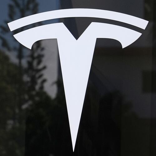 FILE - The Tesla logo is displayed at a Tesla dealership, Mar. 13, 2025, in Miami. (AP Photo/Lynne Sladky, File)