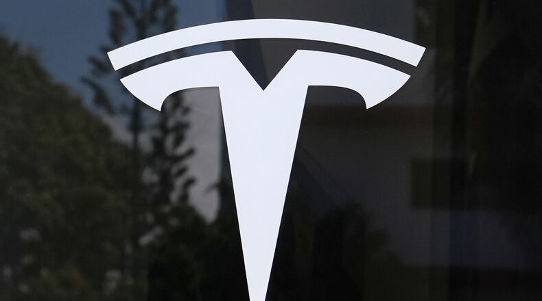FILE - The Tesla logo is displayed at a Tesla dealership, Mar. 13, 2025, in Miami. (AP Photo/Lynne Sladky, File)