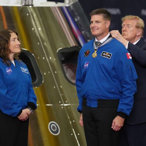 President Donald Trump participates in a Congressional Space Medal of Honor ceremony at NASA's Johnson Space Center, Friday, Aug. 28, 2026, in Houston, and puts a medal on Artemis II Astronaut and Mission Specialist, Jeremy Hansen. (AP Photo/Karen Warren)