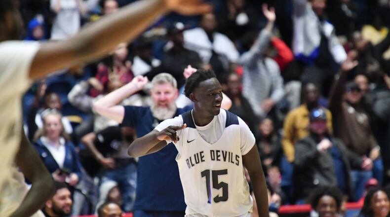 March 12, 2022 Macon - Norcross' Jerry Deng (15) celebrates after dunking the ball at the end of the 4th quarter during the 2022 GHSA State Basketball Class AAAAAAA Boys Championship game at the Macon Centreplex in Macon on Saturday, March 12, 2022. Norcross won 58-45 over Berkmar. (Hyosub Shin / Hyosub.Shin@ajc.com)