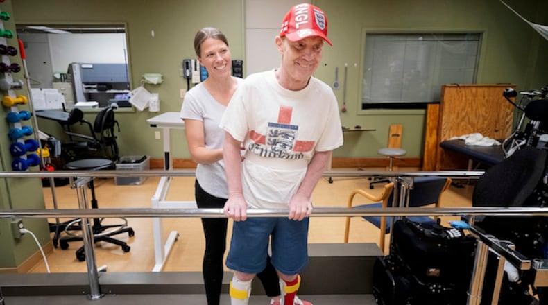 Physical therapist Kim Noha works with Paul Nolan at Courage Kenny Rehabilitation Institute in Golden Valley on June 18, 2018. Nolan was one of the most popular jockeys at Canterbury Park. Now the Bloomington resident is learning to walk again after a serious racing accident last year in Oklahoma that damaged his spinal cord and left him paralyzed. (Carlos Gonzalez/Minneapolis Star Tribune/TNS)