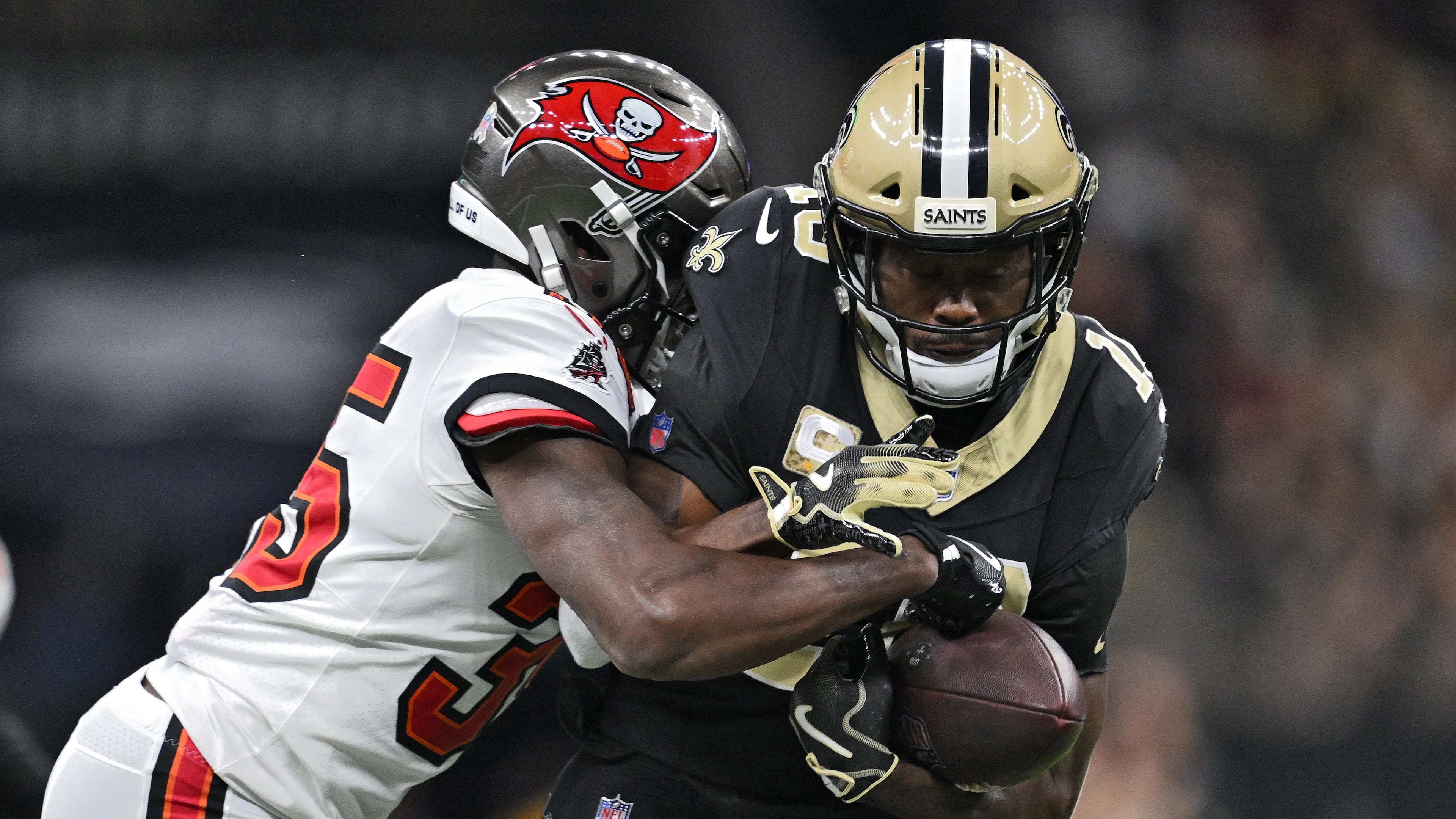 New Orleans Saints wide receiver Brandin Cooks (10) is stopped by Tampa Bay Buccaneers cornerback Jamel Dean (35) after a reception during the second half of an NFL football game Sunday, Oct. 26, 2025, in New Orleans. (AP Photo/Ella Hall)