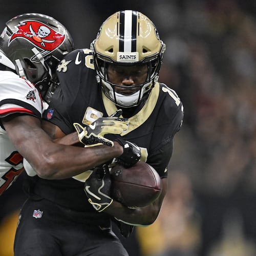 New Orleans Saints wide receiver Brandin Cooks (10) is stopped by Tampa Bay Buccaneers cornerback Jamel Dean (35) after a reception during the second half of an NFL football game Sunday, Oct. 26, 2025, in New Orleans. (AP Photo/Ella Hall)