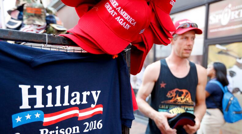 Brad Houston sells souvenirs at Public Square on Tuesday, July 19, 2016, in Cleveland, during the second day of the Republican convention. (AP Photo/John Minchillo)