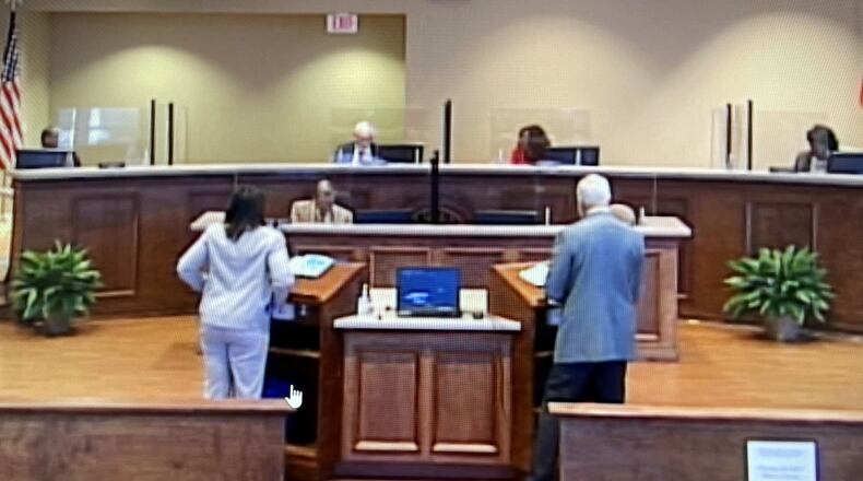 Henry County Commissioners, who have rearranged their seating to meet social distancing guidelines, will not meet Tuesday because of a COVID-19 infection. LEON STAFFORD/AJC