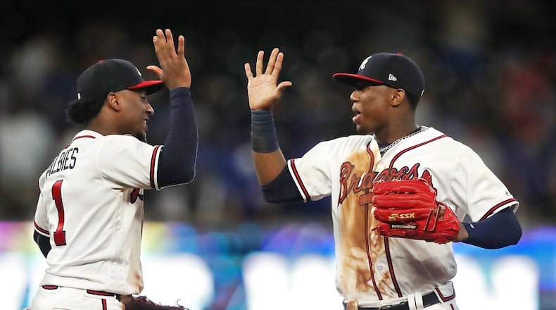 Atlanta Braves Ronald Acuna Jr. and Ozzie Albies celebrate a 4-1 victory over the Chicago Cubs on Wednesday, May 16, 2018, in Atlanta.