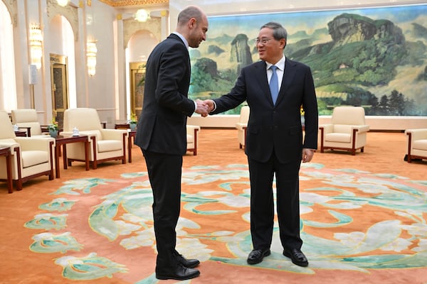 China's Premier Li Qiang, right, greets French Foreign Minister Jean-Noel Barrot prior to their meeting at the Great Hall of the People in Beijing Thursday, March 27, 2025. (Adek Berry/Pool Photo via AP)