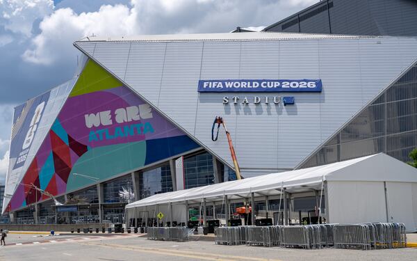 Workers remove a banner from Mercedes-Benz stadium on Friday, July 17, 2026.  (Ben Hendren for the AJC)
