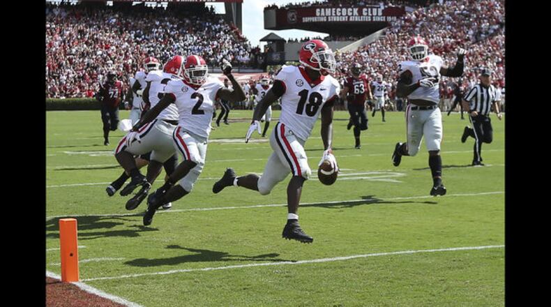 <p> South Carolina head coach Will Muschamp leads the team on their walk into Williams Brice Stadium for an NCAA college football game against Georgia, Saturday, Sept. 8, 2018, in Columbia, S.C. (AP Photo/Sean Rayford) </p> <p> Georgia defensive back Deandre Baker returns an interception for a touchdown during the first quarter during an NCAA college football game against South Carolina, Saturday, Sept. 8, 2018, in Columbia, S.C. (Curtis Compton/Atlanta Journal-Constitution via AP) </p> <p> Georgia running back Elijah Holyfield (13) runs with the ball against South Carolina defensive back Keisean Nixon (9) during the first half of an NCAA college football game Saturday, Sept. 8, 2018, in Columbia, S.C. (AP Photo/Sean Rayford) </p> <p> South Carolina wide receiver Deebo Samuel (1) is tackled by Georgia defensive back J.R. Reed, left, and Deandre Baker (18) during the first half of an NCAA college football game Saturday, Sept. 8, 2018, in Columbia, S.C. (AP Photo/Sean Rayford) </p> <p> Georgia defensive back Deandre Baker (18) and Richard LeCounte (2) celebrate a defensive play against South Carolina during the first half of an NCAA college football game Saturday, Sept. 8, 2018, in Columbia, S.C. (AP Photo/Sean Rayford) </p>