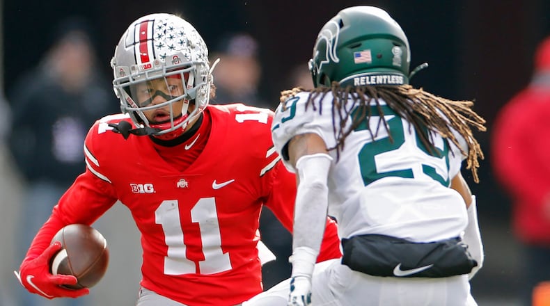 Ohio State wide receiver Jaxon Smith-Njigba (11) tries to get past Michigan State cornerback Marqui Lowery (29) after a catch in the second quarter at Ohio Stadium in Columbus, Ohio, on Saturday, Nov. 20, 2021. (Kyle Robertson/Columbus Dispatch/TNS)