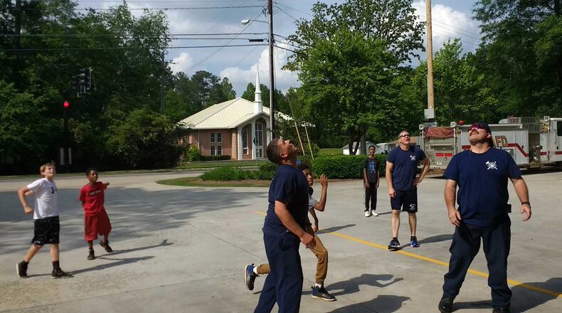 A group of boys was challenged to a game of basketball by Alpharetta firefighters.