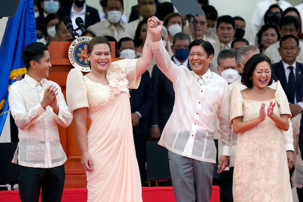 FILE - President Ferdinand Marcos Jr., center right, and Philippine Vice President Sara Duterte, daughter of former Philippine President Rodrigo Duterte, greet during the inauguration ceremony at National Museum on June 30, 2022 in Manila, Philippines. (AP Photo/Aaron Favila, file)