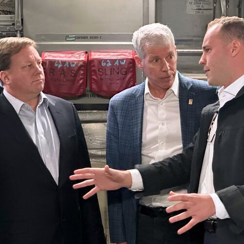 Energy Secretary Chris Wright, center, and Under Secretary of Defense Michael Duffey, left, listen as Isaiah Taylor, CEO of Valar Atomics, discusses a microreactor developed by Valar to generate nuclear power for the military and commercial customers, Sunday, Feb. 15, 2026, in-flight, on board a C-17. (AP Photo/Matthew Daly)