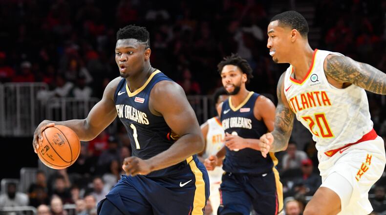 New Orleans Pelicans forward Zion Williamson (1) takes his steal up the floor as Atlanta Hawks forward John Collins (20) follows during the second half of an exhibition basketball game, Monday, Oct. 7, 2019, in Atlanta. The Pelicans won 133-109. (Special/John Amis)