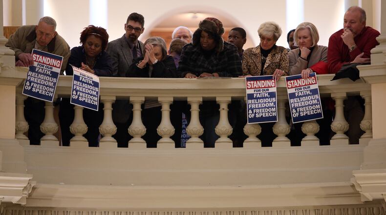 An overflow crowd lines the railings above the state Capitol rotunda during a 2015 rally in support of fired Atlanta fire chief Kelvin Cochran. Ben Gray, bgray@ajc.com