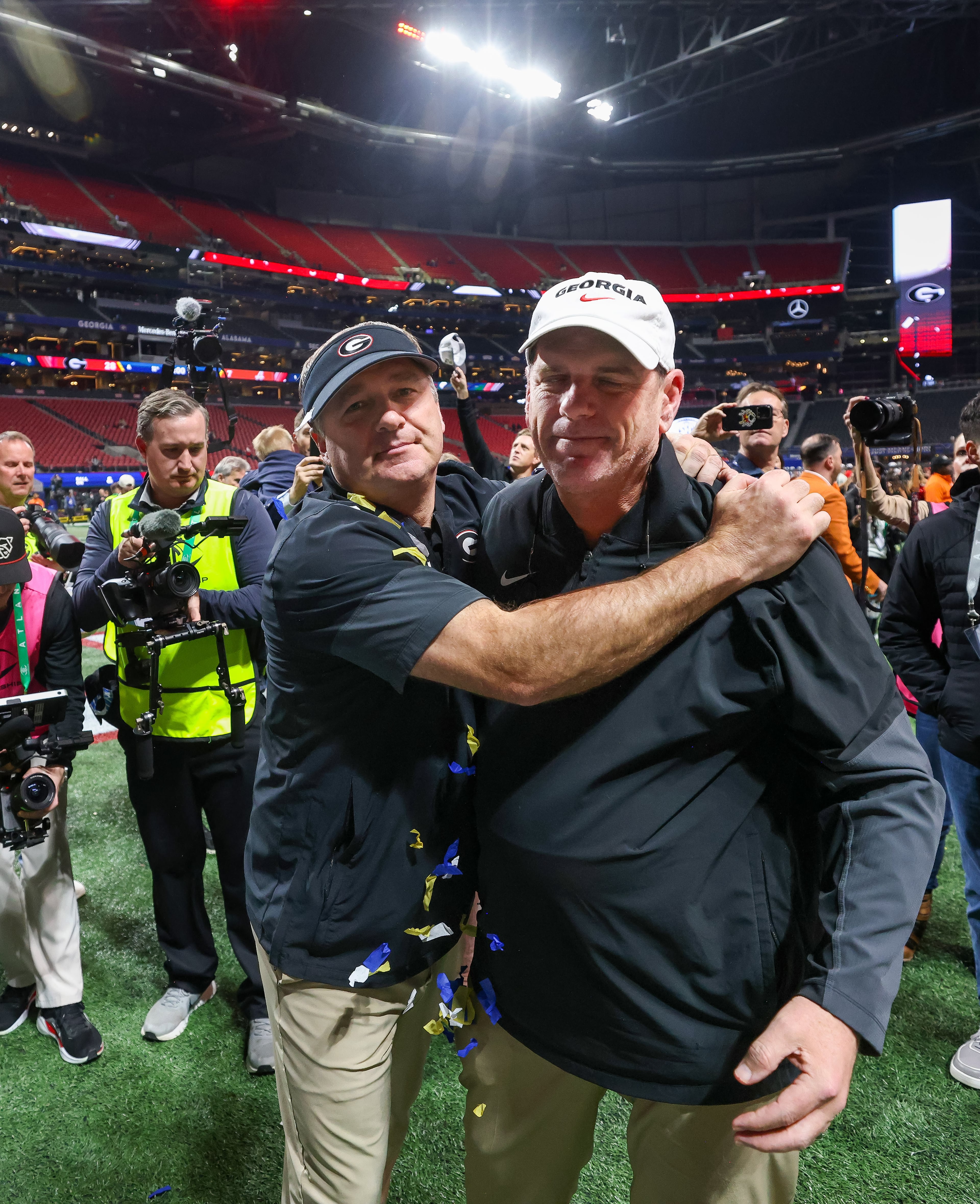 Georgia head coach Kirby Smart celebrates with offensive coordinator Mike Bobo after a 28-7 victory over Alabama in the SEC Championship game at Mercedes-Benz Stadium, Saturday, Dec. 6, 2025, in Atlanta. (Jason Getz / AJC)