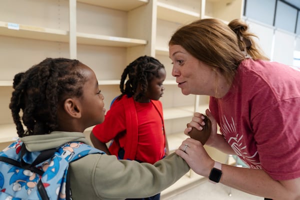 Jillian Murphy high-fives Gaizka Accius, 6, after working through a math problem during the East Providence Boys and Girls Club Summer Camp at Emma G. Whiteknact Elementary School on Thursday, July 10, 2025, in Providence R.I. (AP Photo/Sophie Park)