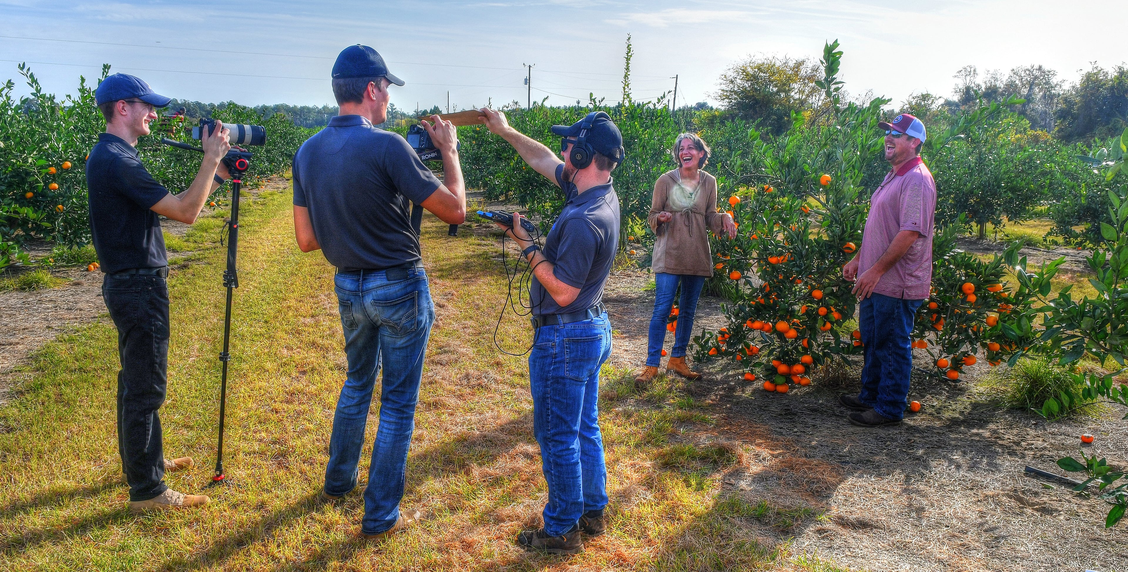 Ligaya Figueras and Justin Corbett prepare to film a demonstration of how to pick a satsuma from the grove during an AJC visit to Corbett Brothers Farms for a 2021 story on Georgia's emerging citrus market. (Chris Hunt for the AJC)