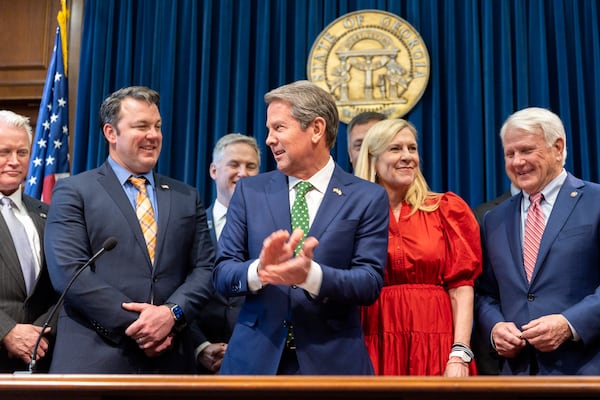Lt. Gov. Burt Jones (left) and Gov. Brian Kemp (center) both took aim at Fani Willis after the Georgia Court of Appeals ruled she should be disqualified from Fulton County's election interference case against Donald Trump and 14 co-defendants. (Arvin Temkar/AJC)