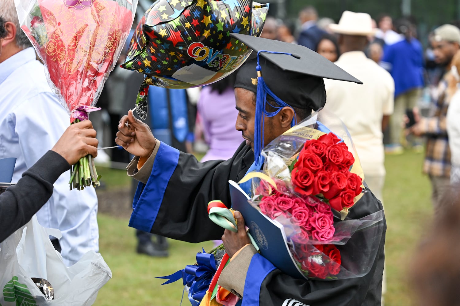 Abrehaa Nedi receives gifts from friends and family members after graduating during Georgia State University’s Spring commencement ceremony for College of Arts & Sciences Wednesday, May 7, 2025 in Atlanta. (Daniel Varnado/For the Atlanta Journal-Constitution)