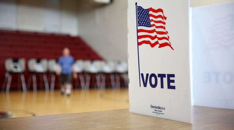 In this file photo, a voter walks away from the voting booths at Henry W. Grady High School in Atlanta on July 24, 2018. (JASON GETZ/SPECIAL TO THE AJC)
