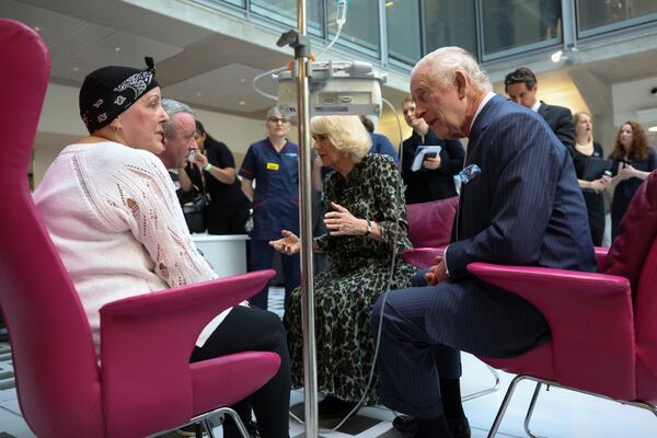 FILE - Britain's King Charles III and Queen Camilla meet with Lesley Woodbridge, patient receiving the second round of chemotherapy for sarcoma and her husband Roger Woodbridge during a visit to the University College Hospital Macmillan Cancer Centre in London, Tuesday April 30, 2024. (Suzanne Plunkett, Pool Photo via AP, File)