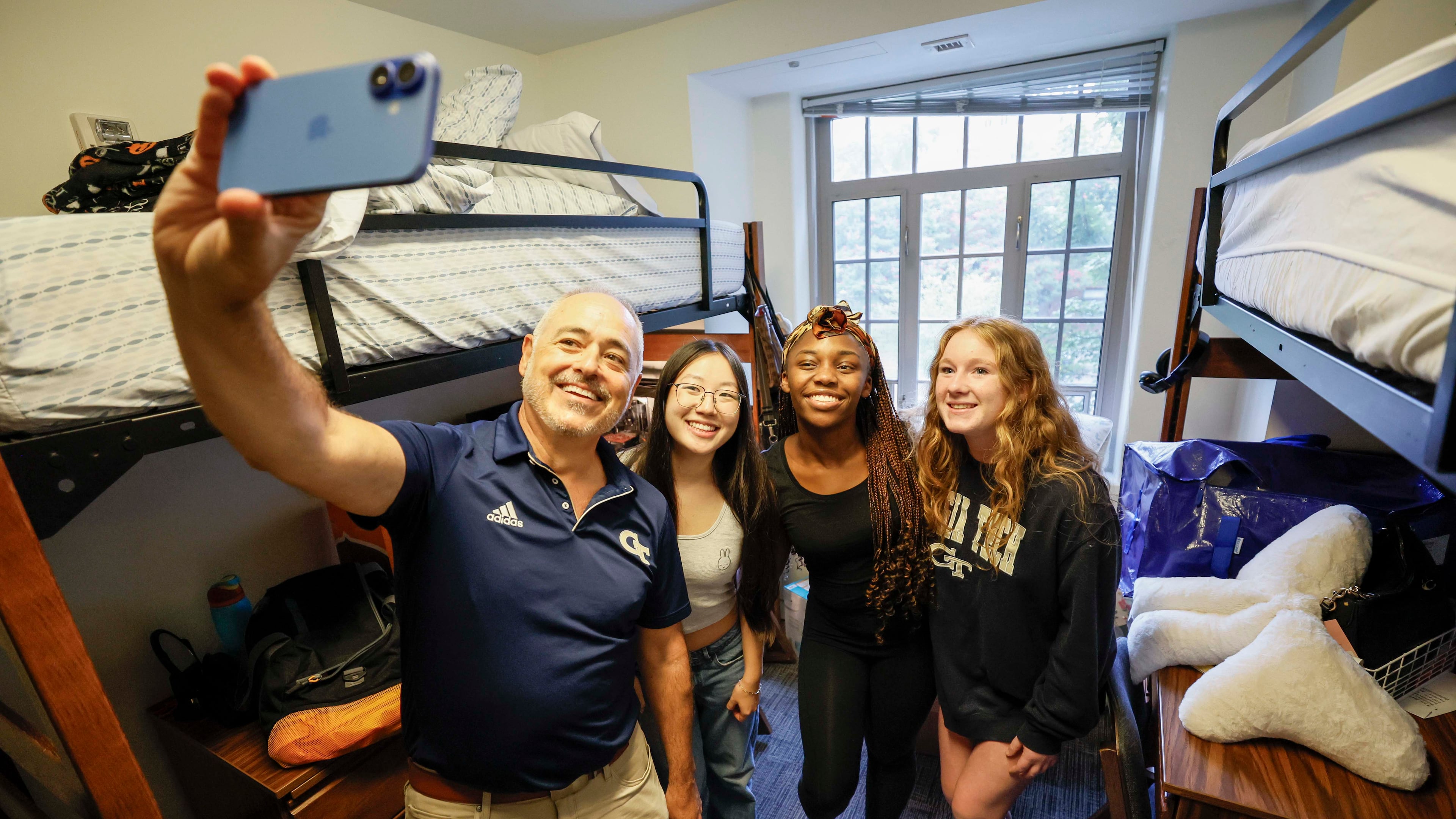 Georgia Tech President Ángel Cabrera takes a selfie with students Jessica Wiriadinata, Alana Lewis and Kylie Johnson during move-in day at Georgia Tech, Sunday, Aug. 10, 2025. (Miguel Martinez/ AJC)