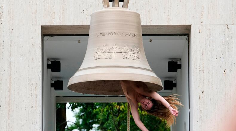 EDS NOTE: NUDITY - A performer rings a bell with her body at the Austrian pavilion called 'Seaworld Venice' by artist Ei Arakawa-Nash, at the Venice 2026 Biennale Art, in Venice, Italy, Thursday, Nov. 14, 2024. (AP Photo/Luca Bruno)