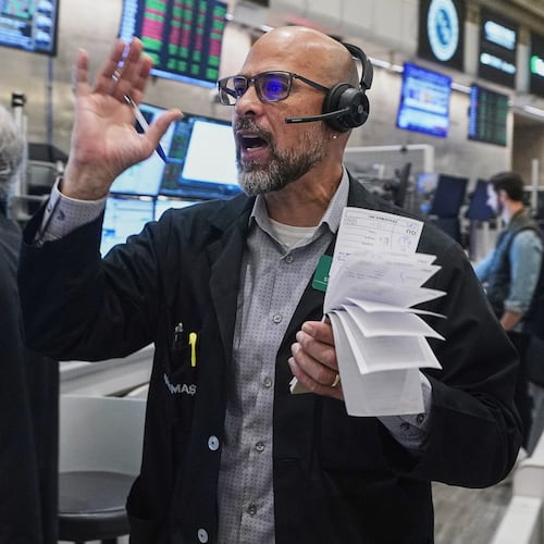 Options trader Steven Rodriguez works on the floor of the New York Stock Exchange, Friday, Nov. 21, 2025. (AP Photo/Richard Drew)