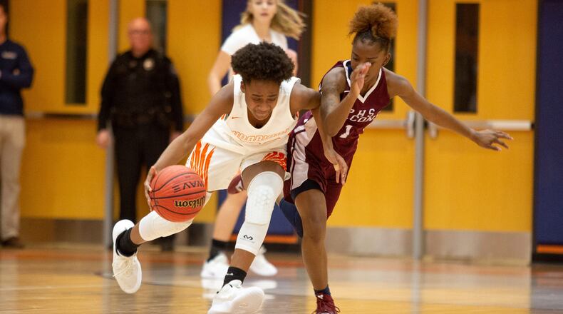 North Cobb High School girls basketball player Dayuna Colin drives past Pebblebrook High School player Jalicia Bass during the first round of the girls' high school basketball tournament at North Cobb High School in Kennesaw February 15, 2018. STEVE SCHAEFER / SPECIAL TO THE AJC