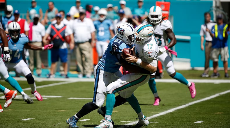 Miami Dolphins quarterback Ryan Tannehill (17) is sacked by Tennessee Titans outside linebacker Derrick Morgan (91) during the first half of an NFL football game, Sunday, Oct. 9, 2016, in Miami Gardens, Fla. (AP Photo/Wilfredo Lee)